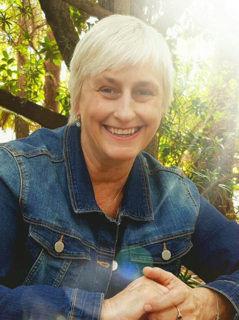 Professor Zelda Knight smiling warmly in a garden setting